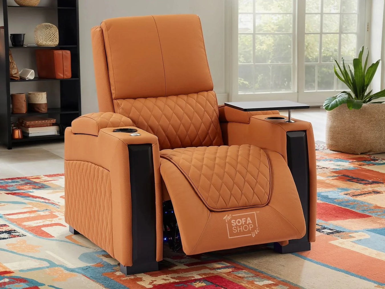 Tan diamond-pattern recliner chair with black armrests, cup holders and side tray in a bright living room